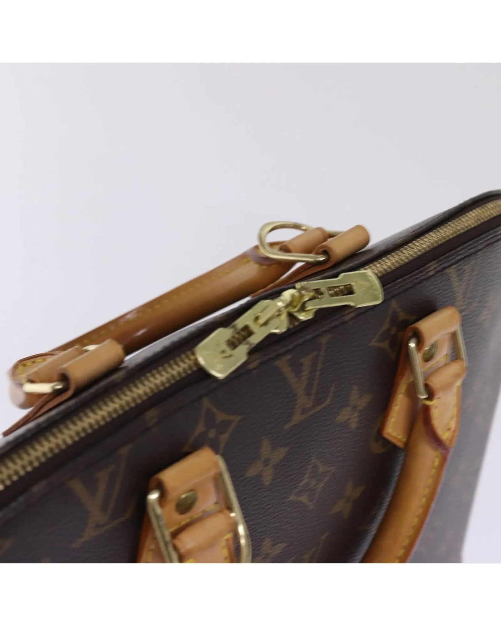 Monogram Canvas Alma Hand Bag with Metal Accents